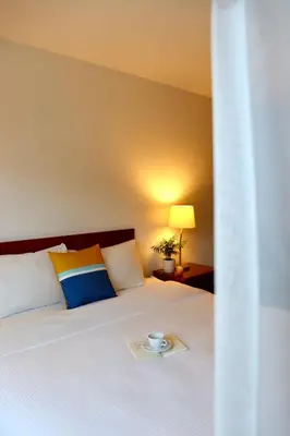 a bed with a plate with a cup on it at August Jack Inn in Squamish