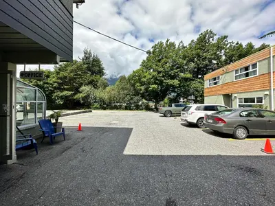 a parking lot with cars parked next to a building at August Jack Inn in Squamish
