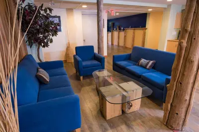 a living room with blue couches and a coffee table at Ocean Resort in Oyster Bay