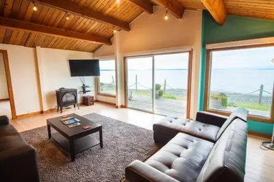 a living room with a couch and a table at Ocean Resort in Oyster Bay