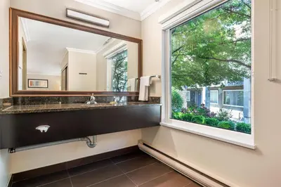 a bathroom with a large window and a sink at Best Western PLUS Burnaby Hotel in Burnaby