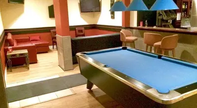 a pool table in a lobby with a bar at Barriere Motor Inn-BMI in Barrière
