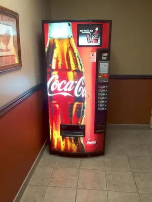a cocacola soda vending machine in a room at Barriere Motor Inn-BMI in Barrière