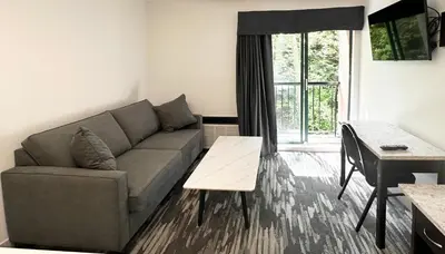 a living room with a couch and a table at Canadian Inn in Surrey