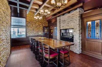 a dining room with a wooden table and chairs at Best Western Plus Edmonton Airport Hotel in Leduc