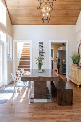 a dining room with a wooden table and chairs at CHATHAM HOUSE Kelowna Bed & Breakfast in Kelowna