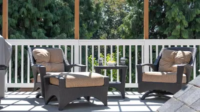 two chairs and a table on a patio at CHATHAM HOUSE Kelowna Bed & Breakfast in Kelowna