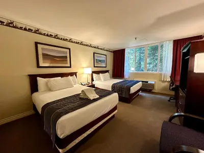 a hotel room with two beds and a window at Harrison Hot Springs Resort & Spa in Harrison Hot Springs
