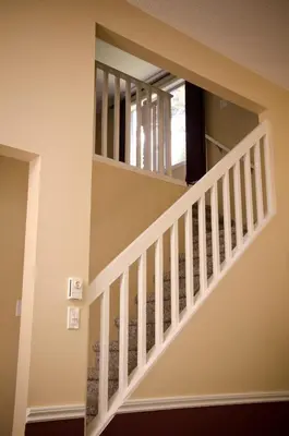 a staircase in a home with white railings at Ocean Trails Resort in Parksville