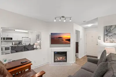a living room with a couch and a fireplace at Ocean Trails Resort in Parksville
