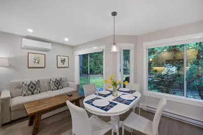 a living room with a table and a couch at Ocean Trails Resort in Parksville