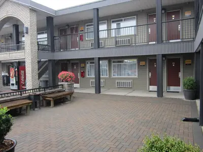a courtyard of a building with benches and windows at Canadas Best Value Inn-Prince George in Prince George
