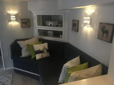 a living room with a couch with pillows on it at Long Lake Waterfront Bed and Breakfast in Nanaimo