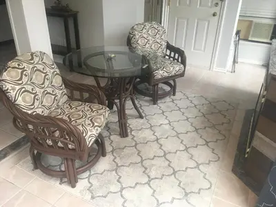 a dining room with a glass table and chairs at Long Lake Waterfront Bed and Breakfast in Nanaimo