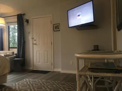 a living room with a flat screen tv on the wall at Long Lake Waterfront Bed and Breakfast in Nanaimo