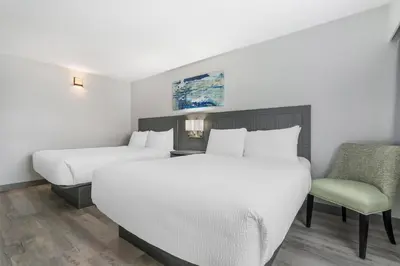 a hotel room with two beds and a chair at Best Western Prince George Downtown in Prince George