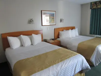 a hotel room with two beds and a window at Ramada Merritt in Merritt