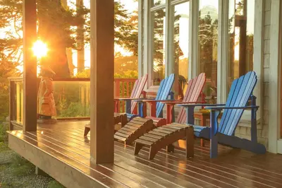 a group of rocking chairs sitting on a porch at Black Rock Beach House in Ucluelet