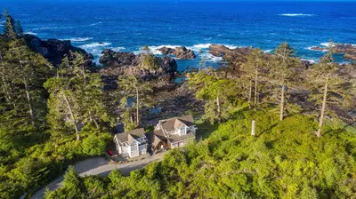an aerial view of a house on a hill next to the ocean at Black Rock Beach House in Ucluelet