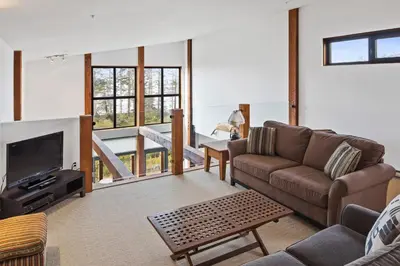 a living room with a couch and a tv at Black Rock Ridge in Ucluelet