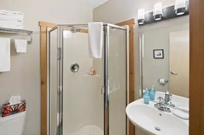a bathroom with a shower and a sink at Black Rock Landing in Ucluelet