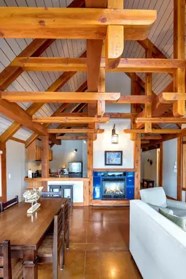 a living room with a table and a fireplace at Black Rock Landing in Ucluelet