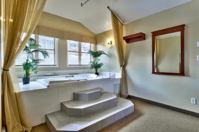 a large bathroom with a tub and a sink at Sun Peaks Lodge in Sun Peaks