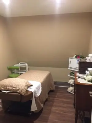 a hospital room with a bed and a table at Spruce Hill Resort & Spa in 108 Mile Ranch