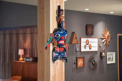 a wooden totem pole in a living room at Hotel Zed Tofino in Tofino