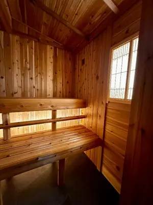 a wooden sauna with a bench in a room at West Coast Motel on the Harbour in Ucluelet