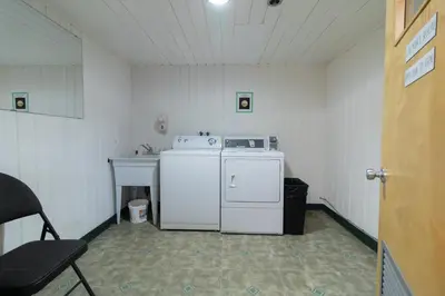 a small kitchen with a white stove and a sink at Super 8 by Wyndham Prince George in Prince George