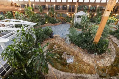 an indoor garden with trees and plants in a building at Super 8 by Wyndham Prince George in Prince George