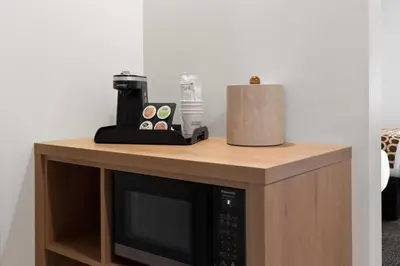 a microwave sitting on top of a wooden counter at Travelodge by Wyndham Blairmore in Blairmore