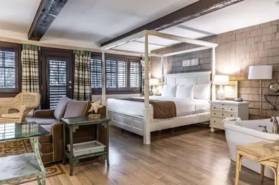 a bedroom with a bed and a couch and a bed and a room with at Prestige Lakeside Resort, WorldHotels Elite in Nelson