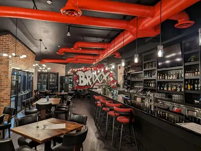 a restaurant with tables and chairs and red pipes at Prestige Lakeside Resort, WorldHotels Elite in Nelson