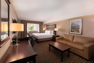 a hotel room with a bed and a couch at Prestige Radium Hot Springs Resort, WorldHotels Crafted in Radium Hot Springs