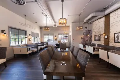 a restaurant with a wooden table and chairs at Prestige Radium Hot Springs Resort, WorldHotels Crafted in Radium Hot Springs