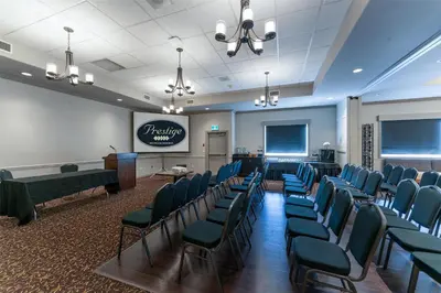 a waiting room with blue chairs and a podium at Prestige Radium Hot Springs Resort, WorldHotels Crafted in Radium Hot Springs