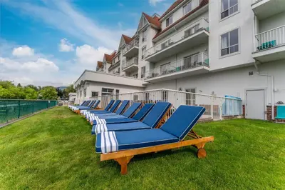 a row of blue chaise lounges in front of a building at Prestige Harbourfront Resort, WorldHotels Luxury in Salmon Arm