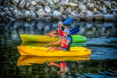 two people are in kayaks on the water at Prestige Inn Nelson in Nelson