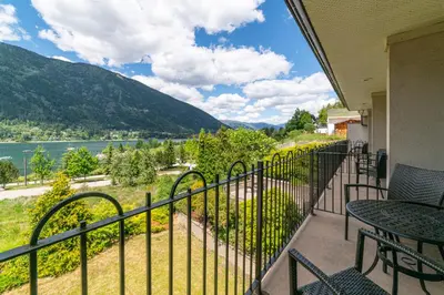 a balcony with a view of a river and mountains at Prestige Inn Nelson in Nelson