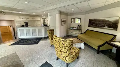 a living room with a couch and a table at Prestige Inn Nelson in Nelson