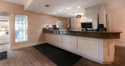 a kitchen with a bar with a sink and a window at Prestige Golden Hotel in Golden
