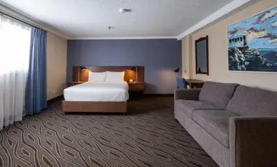 a hotel room with a bed and a couch at Prestige Mountain Resort Rossland in Rossland