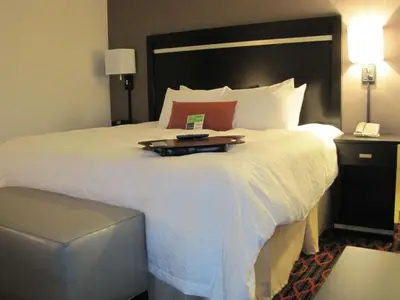 a hotel room with a large bed with a tray on it at Hampton Inn by Hilton Fort Saskatchewan in Fort Saskatchewan