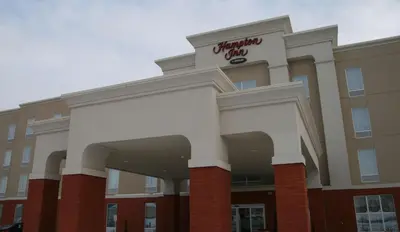 a building with a sign on top of it at Hampton Inn by Hilton Fort Saskatchewan in Fort Saskatchewan