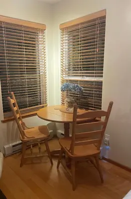 a dining room with a table and two chairs at Cobble Wood and Bird Sanctuary Guest Houses in Tofino