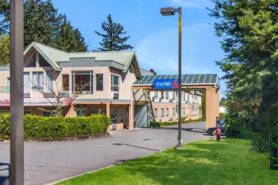 a street sign in front of a building at Motel 6 Surrey, Bc in Surrey