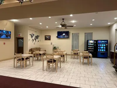 a restaurant with tables and chairs in a room at Lone Star Hotel in North Battleford