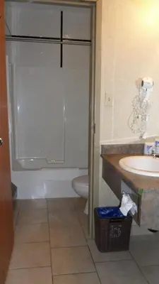 a bathroom with a tub and a sink and a toilet at Lakeview Inns & Suites - Hinton in Hinton